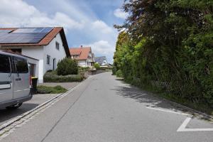 a house with a van parked on the side of a street at Ferienwohnung Pepe in Donaueschingen