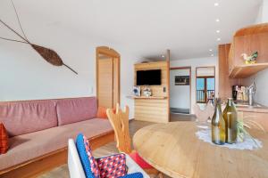 a living room with a couch and a table at Pfösslerhof in Bolzano