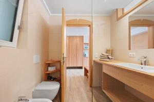 a bathroom with a toilet and a sink at Pfösslerhof in Bolzano +60 photos