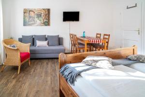 a living room with two beds and a couch at Gästehaus Vis à Vis in Wallhausen