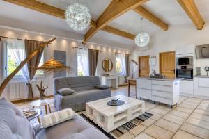 a living room with a couch and a table at Les Bois flottés in Poussan +17 photos