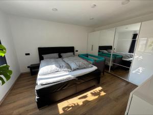 a bedroom with a large bed and a mirror at Ferienwohnung Am Biohof in Mengkofen