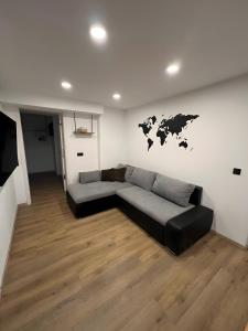 a living room with a couch and a map on the wall at Ferienwohnung Am Biohof in Mengkofen