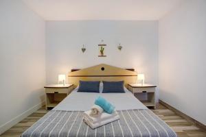 a bedroom with a bed with a dog on a towel at Funchal Boa Nova Apartment in Funchal