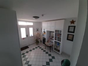 a hallway with a room with a table and book shelf at Villa Bella Vista - Meerblick 2 in Sassnitz