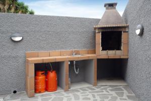a play house with a sink and two orange tanks at Funchal Boa Nova Apartment in Funchal +17 photos