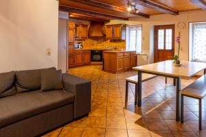 a living room with a couch and a table at Gite Tikilou 6 Pers proche montagne in La Tour-dʼAuvergne +12 photos