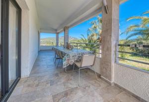 a dining room with a table and chairs on a balcony at Costacabana - Villa Jaruco in Lloret de Mar