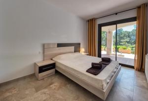 a bedroom with a bed and a large window at Costacabana - Villa Jaruco in Lloret de Mar +27 photos