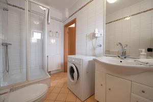 a bathroom with a washing machine and a sink at PrimeStayBudapest in Budapest +37 photos