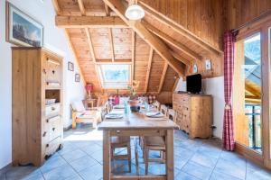 a dining room with a wooden table in a house at La Mouliniere 1 in Valloire