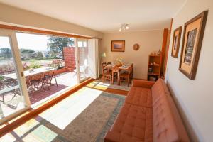 a living room with a couch and a dining room at Bahia Sea View Apartment in Caminha