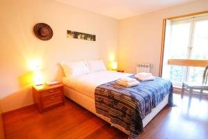 a bedroom with a bed with two towels on it at Bahia Sea View Apartment in Caminha
