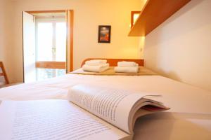 a bedroom with a bed with an open book on it at Bahia Sea View Apartment in Caminha +43 photos