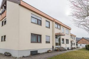 a white house with black windows at Heidis Dihei in Büsingen