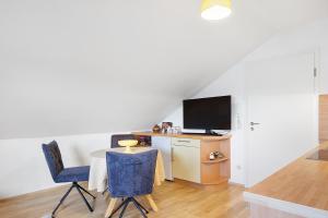 a living room with a table and a tv at Ferienwohnung Eulennestle in Lenzkirch