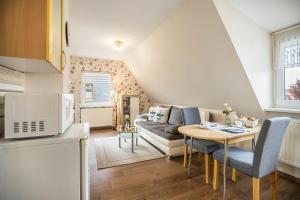 a kitchen and living room with a couch and a table at Kleiner Priel in Dorum