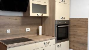 a kitchen with white cabinets and a stove top oven at Ferienhaus mit Sauna am Waldrand in Friedrichroda