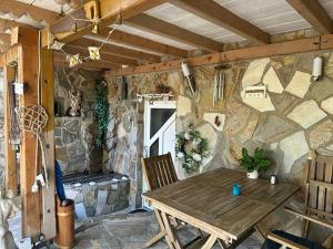a room with a wooden table and a stone wall at Ferienwohnung Insel Reichenau in Rheinstraße