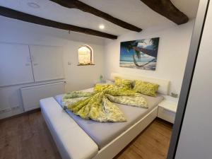 a bedroom with a bed with a yellow comforter at Ferienwohnung Insel Reichenau in Rheinstraße