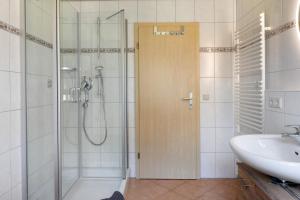 a bathroom with a shower and a sink at Hinterbauernhof Fewo Kuhgeflüster in Stegen +17 photos