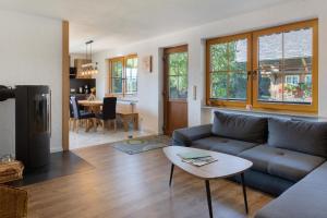 a living room with a couch and a table at Hinterbauernhof Fewo Kuhgeflüster in Stegen