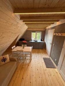 a living room with a table and a couch at Apartamenty u Załogi in Zakopane