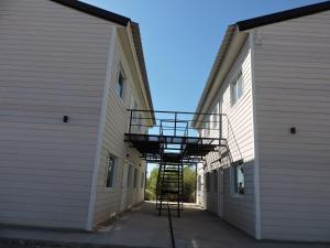 a stairway in between two buildings with a ladder at El Portal Los Álamos in Rincon de los Sauces +2 photos
