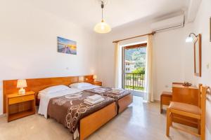 a bedroom with a bed and a window at Mires House Apartment 11 in Agios Gordios