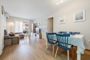 a living room with a table and chairs and a couch at Apartamentos Cunidor - Cunit in Cunit