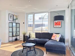 a living room with a couch and a table at Floating Home Nr 1a in Laboe