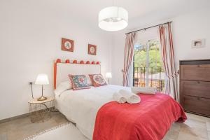 a bedroom with a bed with a red blanket and a window at Villa Alma Azul in Llucmajor +21 photos