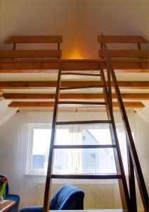 a loft bed in a room with a window at Haus Wehrle in Breisach am Rhein