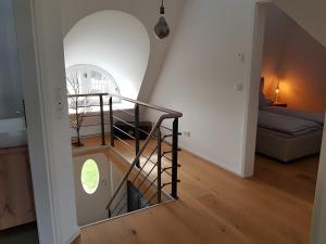a spiral staircase in a room with a window at Schäferhaus in Hemme