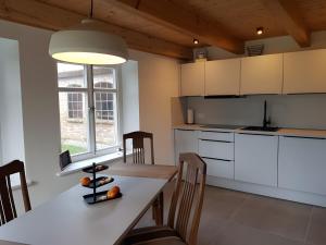a kitchen with a table with a wine bottle on it at Schäferhaus in Hemme