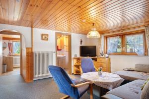 a living room with a couch and a table at Willmannshof in Furtwangen