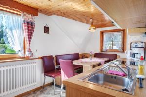 a kitchen with a sink and a table at Willmannshof in Furtwangen