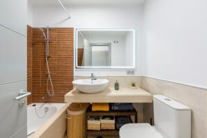 a bathroom with a sink and a toilet and a mirror at Golf Beach Vera in Vera +14 photos