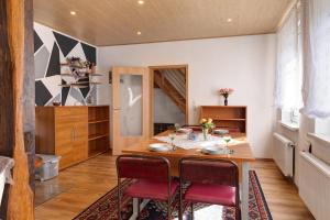 a dining room with a wooden table and red chairs at Ferienwohnung Ruhezone in Gardelegen