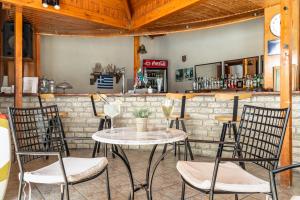 a table and chairs in front of a bar at Marketos studio 2 in Kefallonia