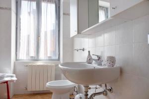 a white bathroom with a sink and a toilet at La Piazzetta in Germignaga +11 photos