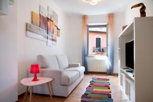 a living room with a white couch and a red lamp at La Piazzetta in Germignaga