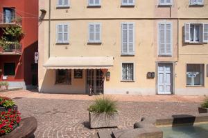 a building with a white awning in front of it at La Piazzetta in Germignaga