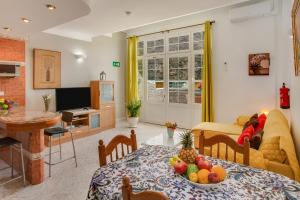 a living room with a table with a bowl of fruit on it at Casa Paco in Mogán
