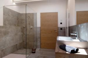 a bathroom with a sink and a shower at Living Lerchna - Schöne Aussicht in Maranza +22 photos