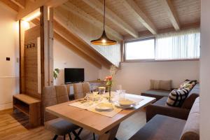 a dining room and living room with a table at Living Lerchna - Schöne Aussicht in Maranza