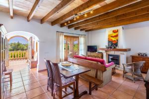 a living room with a table and a couch at Sa Carbona in Artá