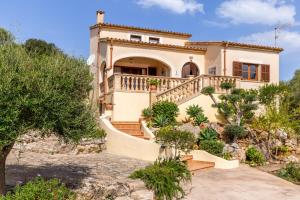 a large house on a hill with stairs at Sa Carbona in Artá