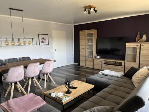 a living room with a couch and a table at Haus Blumenglück in Herscheid +66 photos