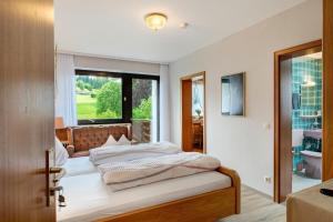 a bedroom with a bed and a window at Haus Seiler in Freudenstadt
